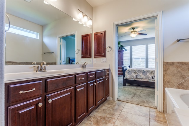 bathroom with a bathing tub, tile patterned flooring, vanity, and ceiling fan