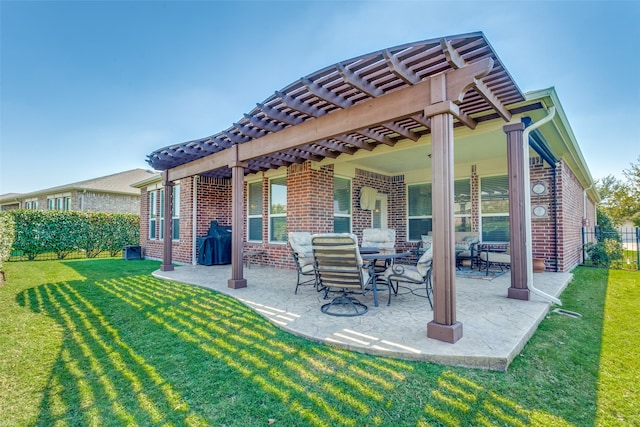 rear view of house with a pergola, a lawn, and a patio area