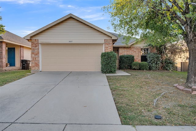 ranch-style house featuring a garage and a front lawn