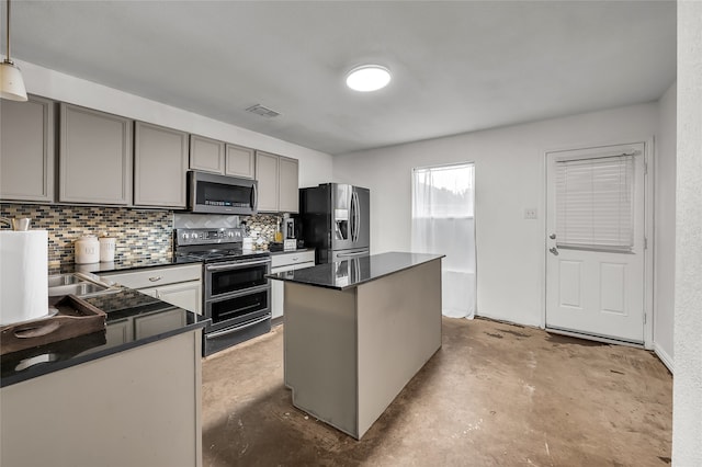 kitchen with decorative backsplash, a center island, concrete flooring, pendant lighting, and appliances with stainless steel finishes