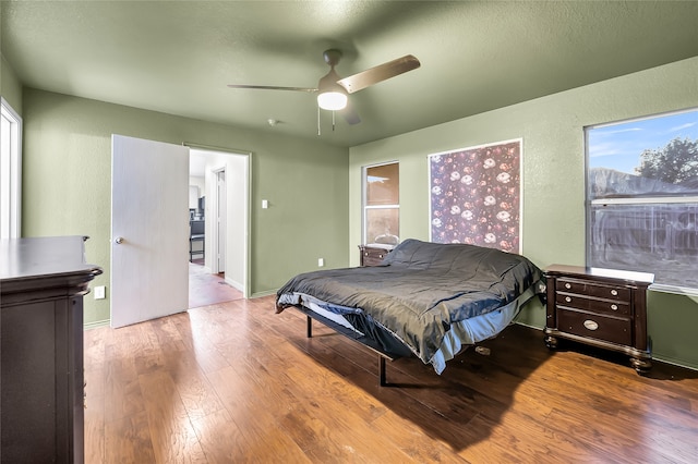 bedroom with wood-type flooring and ceiling fan