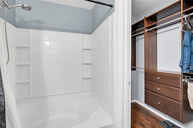 bathroom featuring shower / bath combination with curtain and hardwood / wood-style flooring