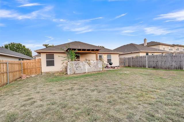 rear view of property with a lawn