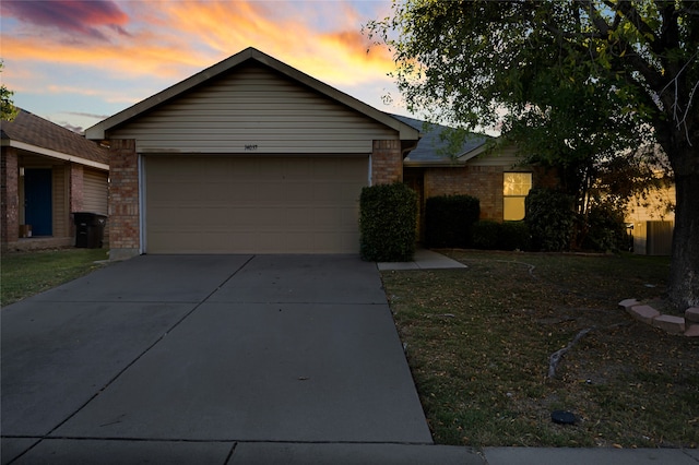 single story home with a lawn and a garage