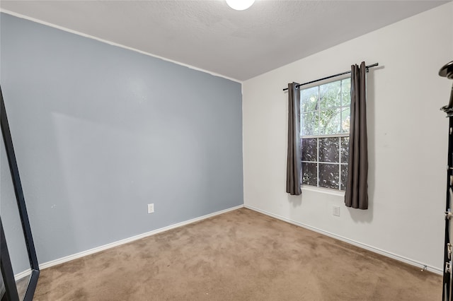 carpeted spare room with a textured ceiling