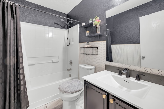 full bathroom with vanity, shower / tub combo, toilet, and tile patterned floors