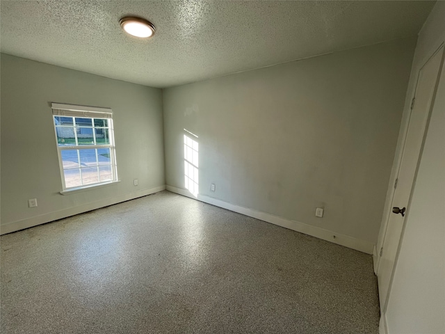 empty room with a textured ceiling