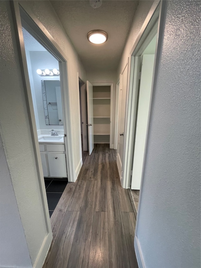 hallway with sink and dark hardwood / wood-style flooring