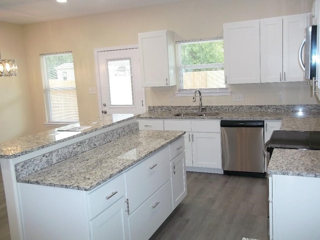 kitchen with stainless steel appliances, white cabinetry, a healthy amount of sunlight, and sink