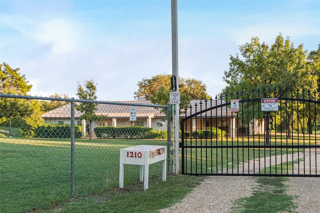 view of gate featuring a yard