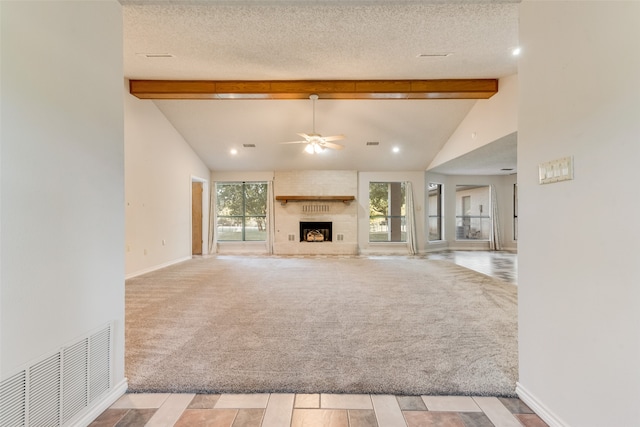 unfurnished living room featuring beamed ceiling, light carpet, a textured ceiling, and ceiling fan