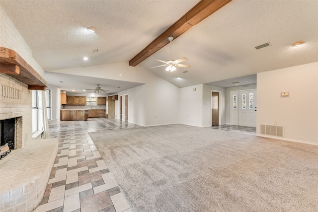 unfurnished living room featuring vaulted ceiling with beams, light carpet, and ceiling fan