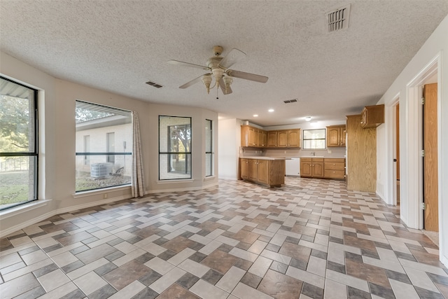 kitchen with dishwasher, sink, a textured ceiling, and ceiling fan