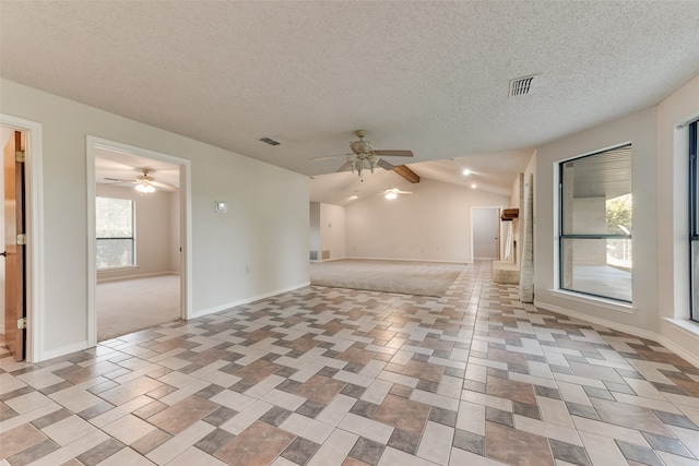 unfurnished room featuring ceiling fan, a textured ceiling, and vaulted ceiling with beams