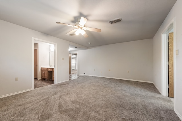 unfurnished bedroom with connected bathroom, ceiling fan, and carpet