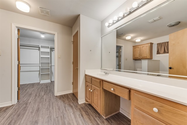 bathroom featuring vanity, toilet, and wood-type flooring