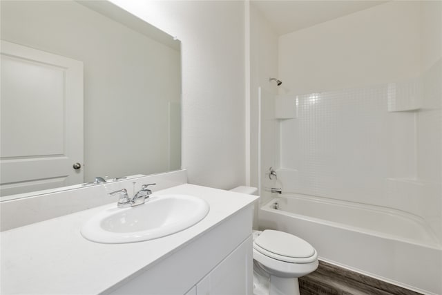 full bathroom featuring bathtub / shower combination, wood-type flooring, vanity, and toilet