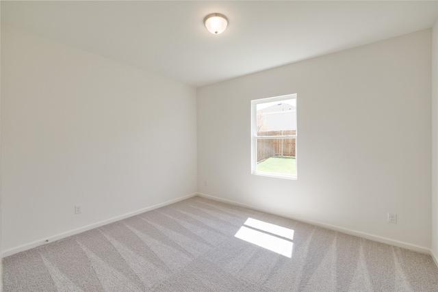 unfurnished room with light colored carpet