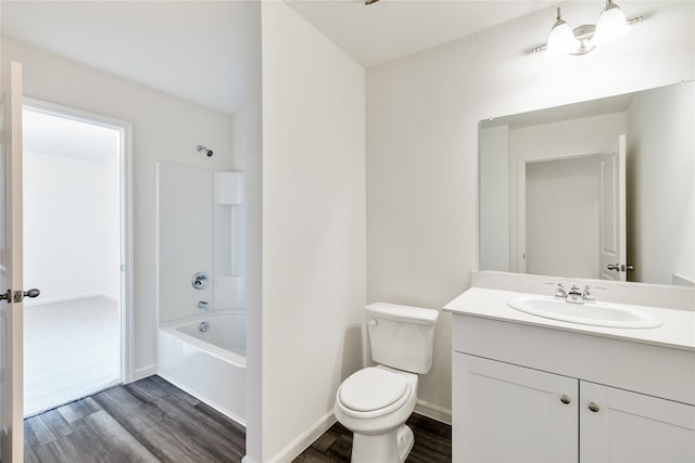 full bathroom featuring  shower combination, vanity, hardwood / wood-style floors, and toilet