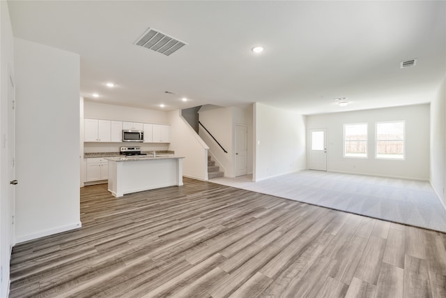 unfurnished living room with light hardwood / wood-style flooring