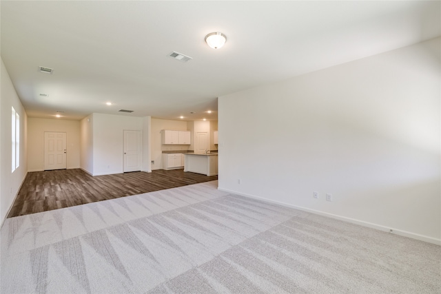 unfurnished living room with light carpet