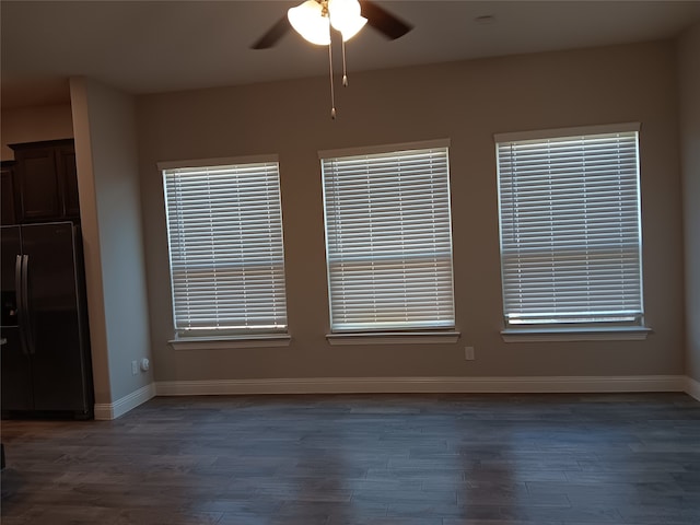 unfurnished room with dark hardwood / wood-style floors and ceiling fan