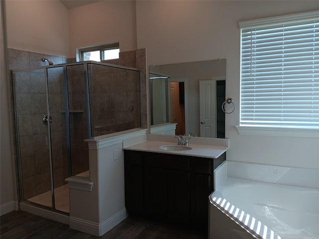 bathroom featuring vanity, separate shower and tub, and hardwood / wood-style flooring