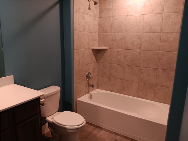 full bathroom with vanity, tiled shower / bath combo, and toilet