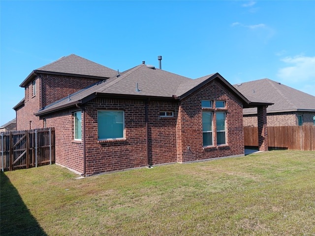 rear view of property featuring a yard