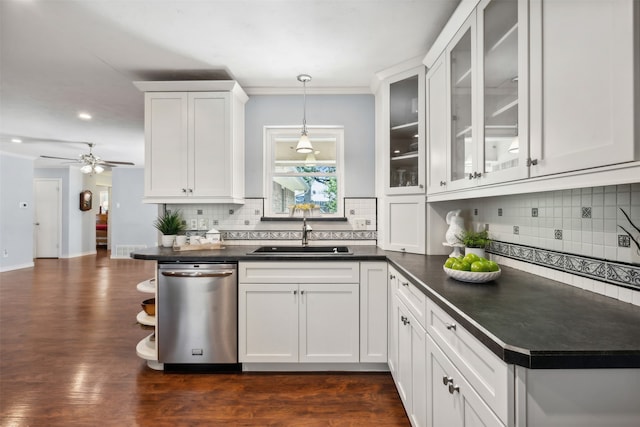 kitchen featuring hanging light fixtures, white cabinetry, dark wood-type flooring, dishwasher, and sink