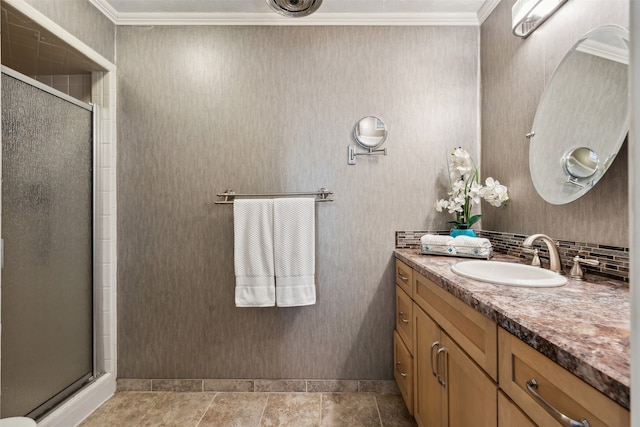 bathroom with crown molding, vanity, tile patterned floors, and a shower with door