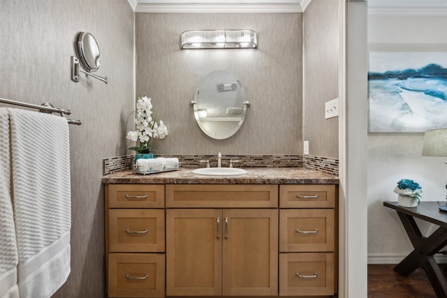 bathroom featuring crown molding, vanity, and wood-type flooring