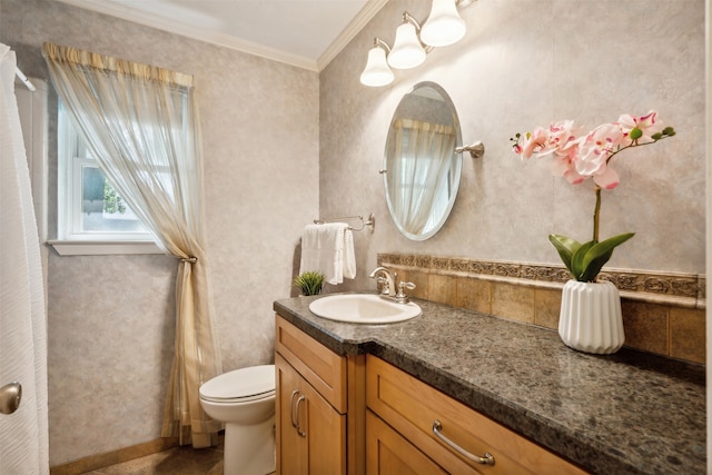 bathroom featuring ornamental molding, vanity, and toilet