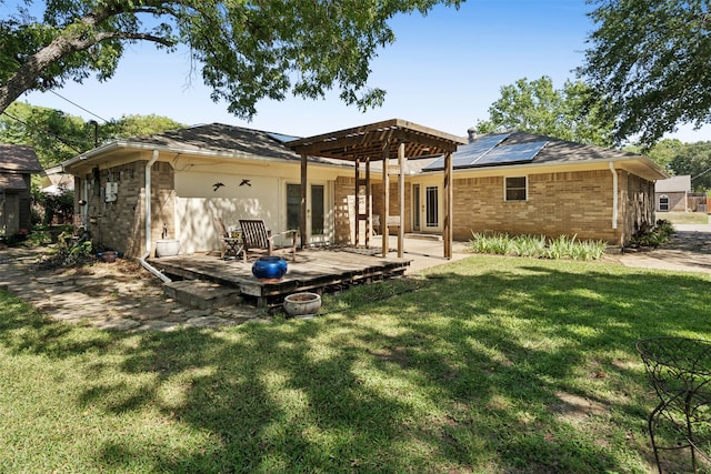 rear view of house featuring a pergola, a wooden deck, a yard, and a patio area