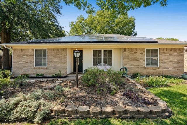 ranch-style home with solar panels