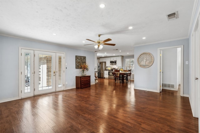 unfurnished living room with ceiling fan, ornamental molding, dark hardwood / wood-style flooring, and a healthy amount of sunlight