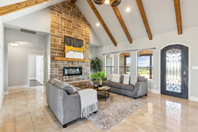 living room with a fireplace, high vaulted ceiling, and beamed ceiling