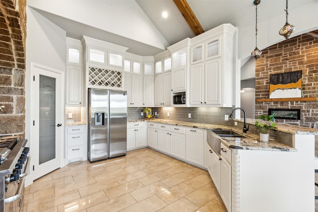 kitchen featuring white cabinetry, sink, beamed ceiling, pendant lighting, and appliances with stainless steel finishes