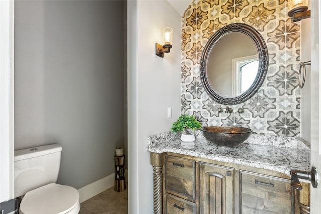 bathroom featuring tile patterned flooring, vanity, and toilet