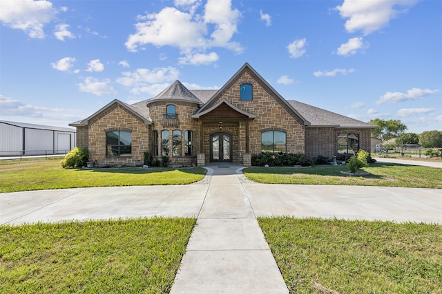 view of front of property with french doors and a front yard