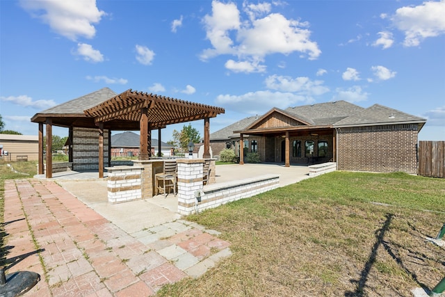 view of property's community featuring a pergola, a patio area, a lawn, and an outdoor bar