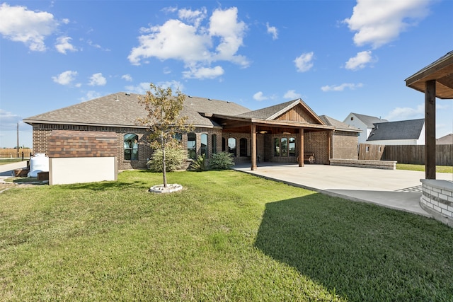 back of property with a patio and a lawn