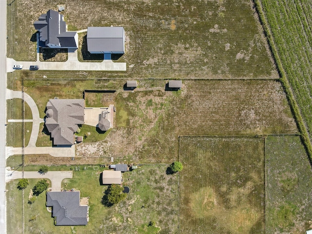 birds eye view of property with a rural view