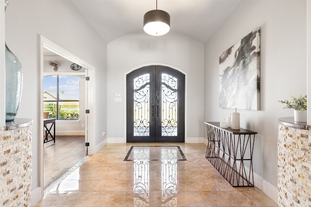 entryway with vaulted ceiling and french doors