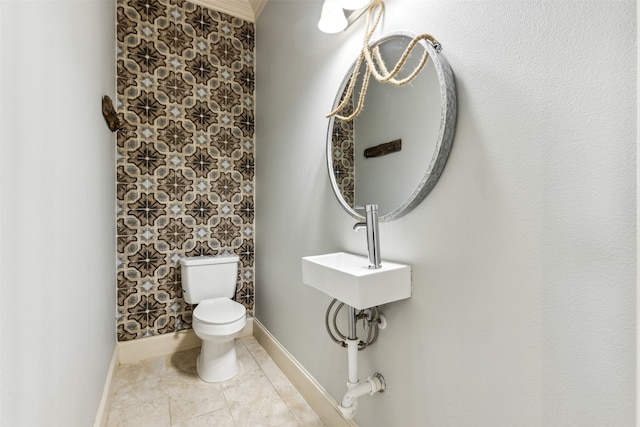 bathroom with tile patterned flooring, toilet, and sink