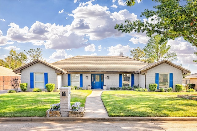 single story home with brick siding, a front lawn, and fence