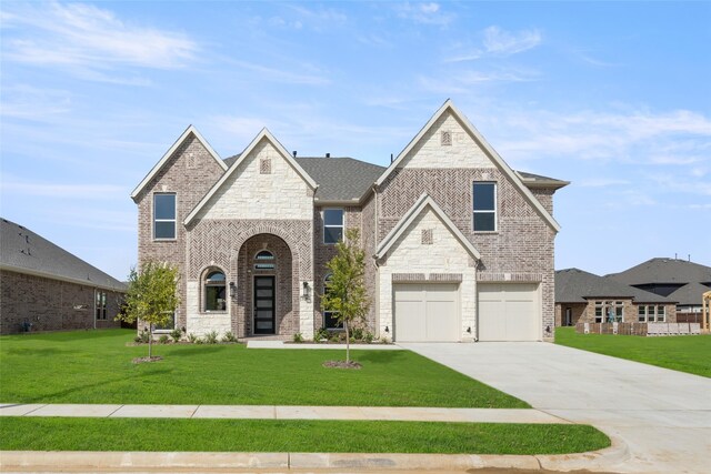 view of front facade featuring a garage and a front lawn