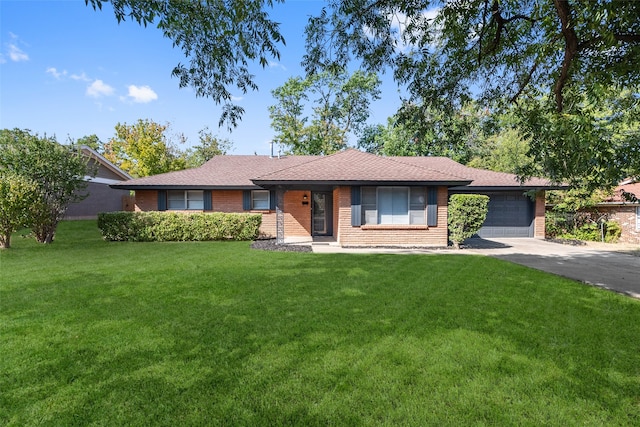 single story home featuring a garage and a front yard