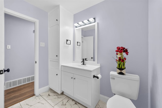 bathroom featuring vanity, toilet, and hardwood / wood-style flooring