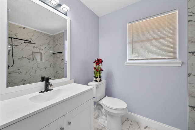 bathroom featuring tiled shower, vanity, and toilet